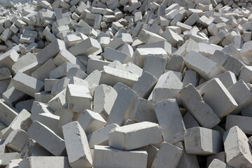 Fototapeta premium A large pile of gray sand-lime bricks. The concept of starting construction and a new life