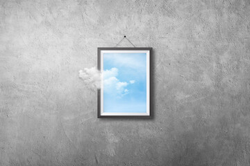 Abstract image of White cloud flying out from picture or photo frame that hanging on concrete wall grunge texture background.