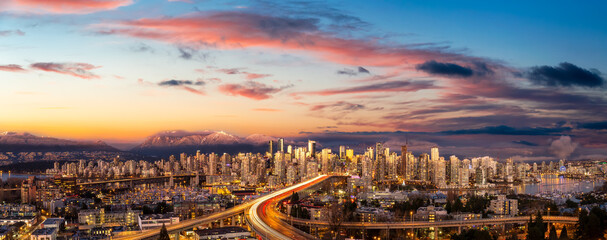 Fototapeta premium Aerial Panoramic view of Downtown Vancouver, Cambie Bridge, and False Creek. Picture taken during a cloudy sunset. Colorful sky Overlay.