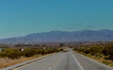 American make big rig semi truck transporting reefer fast on mountain highway