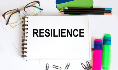 White notes with inscription 'resilience' on beautiful black table. Business concept.