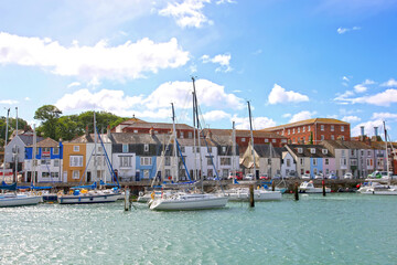 Sailing boats in the old town of Weymouth Harbour in Dorset, England, UK.