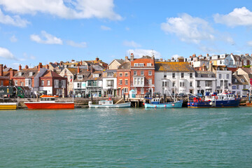 Sailing boats in the old town of Weymouth Harbour in Dorset, England, UK.