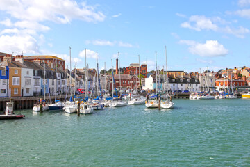 Sailing boats in the old town of Weymouth Harbour in Dorset, England, UK.