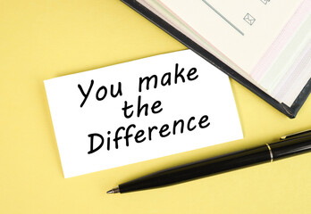you make the difference. text on white paper on yellow background