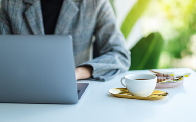 Closeup image of a business woman using and working on laptop computer in office