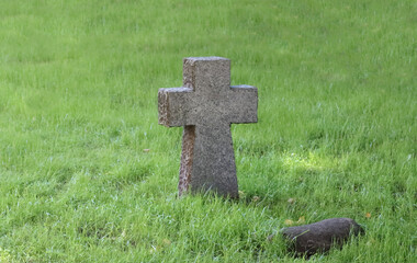 An old, Catholic cross in a clearing.