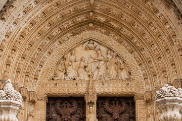 Gothic ancient architecture and design. Closeup view of the textures and sculptures in the  Door of Lions in Toledo Cathedral, Spain.  - obrazy, fototapety, plakaty