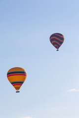 Fototapeta na wymiar Hot air balloons profiled on clear blue sky, in Cappadocia, Turkey