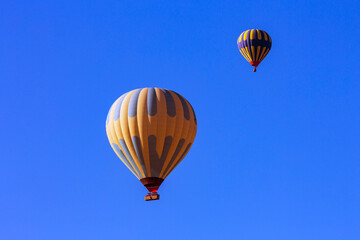 Hot air balloons profiled on clear blue sky, in Cappadocia, Turkey