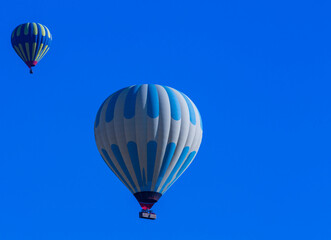 Hot air balloons profiled on clear blue sky, in Cappadocia, Turkey