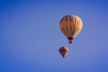 Fototapeta premium Hot air balloons profiled on clear blue sky, in Cappadocia, Turkey