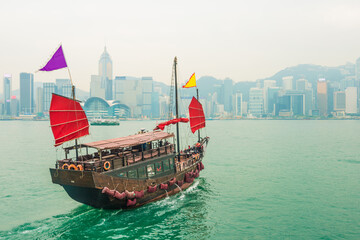 Hong Kong victoria harbour with tourist junk red flag boat
