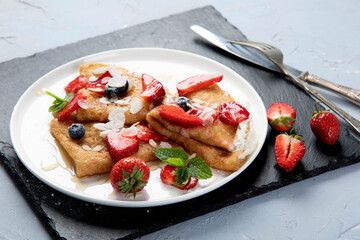 Traditional crepes with filling on gray background