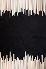 Vertical background with Japanese noodles on black