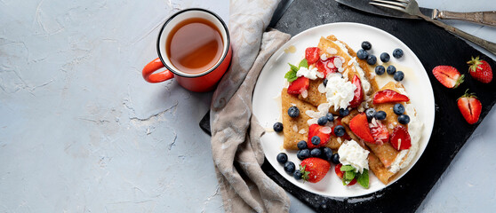 Traditional crepes with filling on gray background