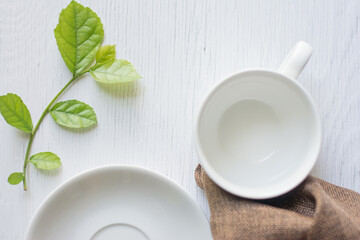 Close up hand cleaning coffee cup on the morning with microfiber cloth,Close up woman hand cleaning coffee cup on the rustic wood table.