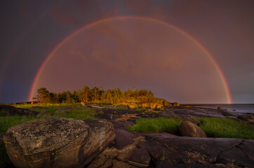 Rainbow over the rocks. Arctic. Kiy Island in the White Sea
