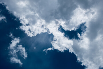 floating white cloud in bright blue sky in sunny day