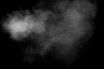 White powder explosion clouds.Freeze motion of white dust particles splash on black background.