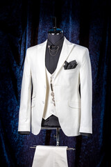 Groom's wedding suit on a mannequin or dummy. men's white three-piece suit with a scarf in his...