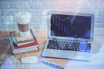 Multi exposure of chart and financial info and work space with computer background. Concept of...