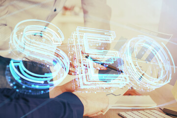 Man hands writing. With double exposure seo drawings.