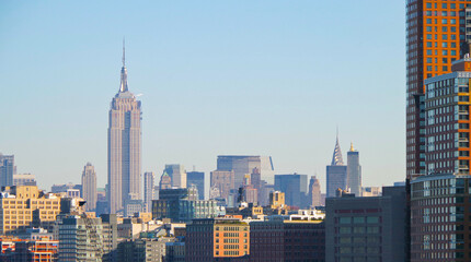 Empire State Building with skyline and skyscrapers of midtown Manhattan in famous travel...