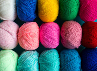 Colorful multicolored background from skeins of acrylic yarn. Textile industry.