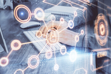 Social network theme hologram with businessman working on computer on background. Concept of world wide web. Multi exposure.