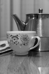 Close up shot of a kettle and a cop of coffee