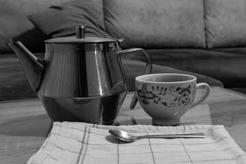 Close up shot of a kettle and a cop of coffee
