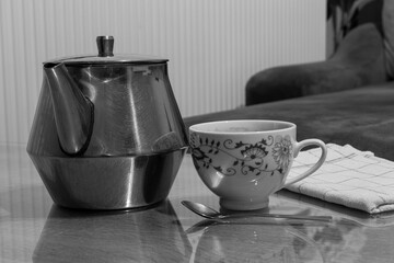 Close up shot of a kettle and a cop of coffee