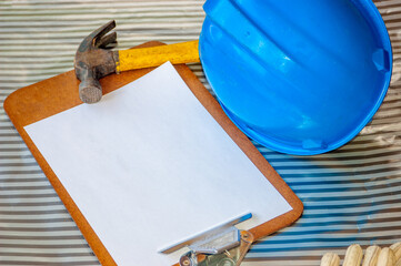 Construction  tools- helmet, hammer, and writing  pad