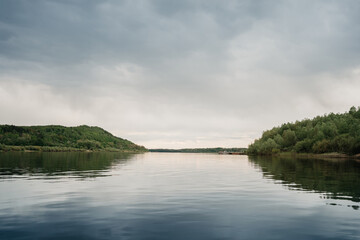 calm river on an overcast day in summer