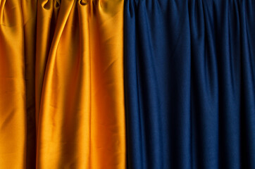 Dark yellow and blue draped curtains.Empty space for design