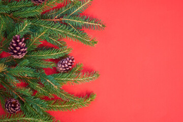 Fototapeta na wymiar Christmas background with xmas tree on red canvas background. Merry christmas card. Winter holiday theme. Happy New Year. Space for text. christmas backdrop top view. Flat lay.