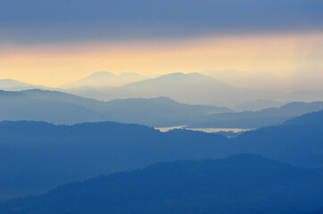 Fototapeta na wymiar Foggy layered mountain landscape in North of Thailand
