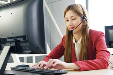 Businesswoman Call Center and technical Support staff with headset Smiling and talking in work....