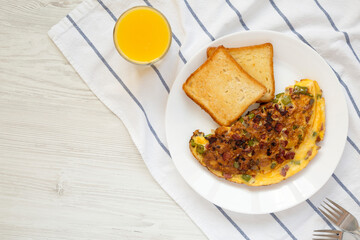 Homemade Denver Omelette on a white plate on cloth, top view. Flat lay, overhead, from above. Copy space.