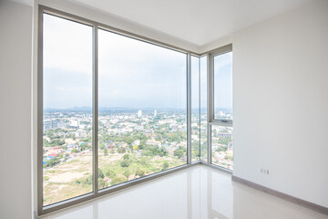 glass balcony with sky view of apartment, big and clean window of white room interior.