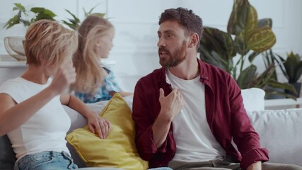 Frustrated parents couple man and woman making up conflict on family problems in the house. Disobedient kids having fun running around. Disrespectful relations.