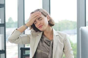 Businesswoman so tried headache and suffering stress working at office computer table.