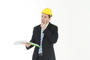 Handsome and smart engineer in black suit Wearing a yellow safety engineering hat with hand holding Construction drawing papers and serious in work isolated on yellow background. Copy Space
