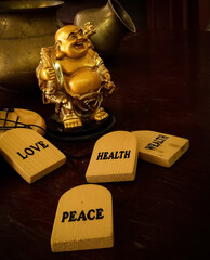 Laughing Buddha idol with pots in the background. The idol is a prestigious symbol in Buddhism.