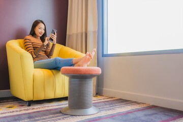 Portrait beautiful young asian woman relax smile in action on sofa