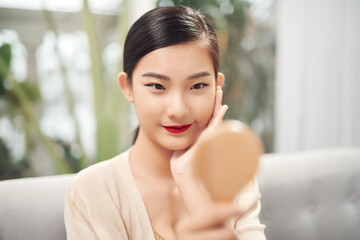 Asian pretty woman holding mirror