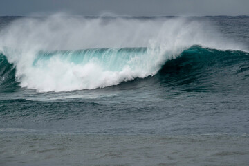 Bib waves rolling into the beach, massive surf day