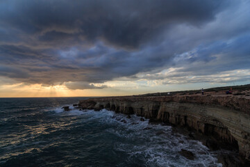 Stormy Weather sunset at sea Caves in Cape Grego Ayia Napa, Cyprus 