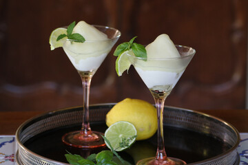 cocktail glasses of lemon sorbet flavored with basil and lime - obrazy, fototapety, plakaty